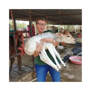 Anita Grabowski holding a rescued calf at Animal Aid Unlimited in Udaipur India