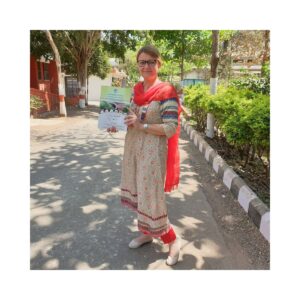 Anita Grabowski at Nisargopchar Ashram in Pune India walking outdoors in traditional clothing